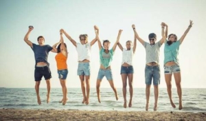 multiethnic-group-of-people-jumping-at-beach-teenagers-young-476451219